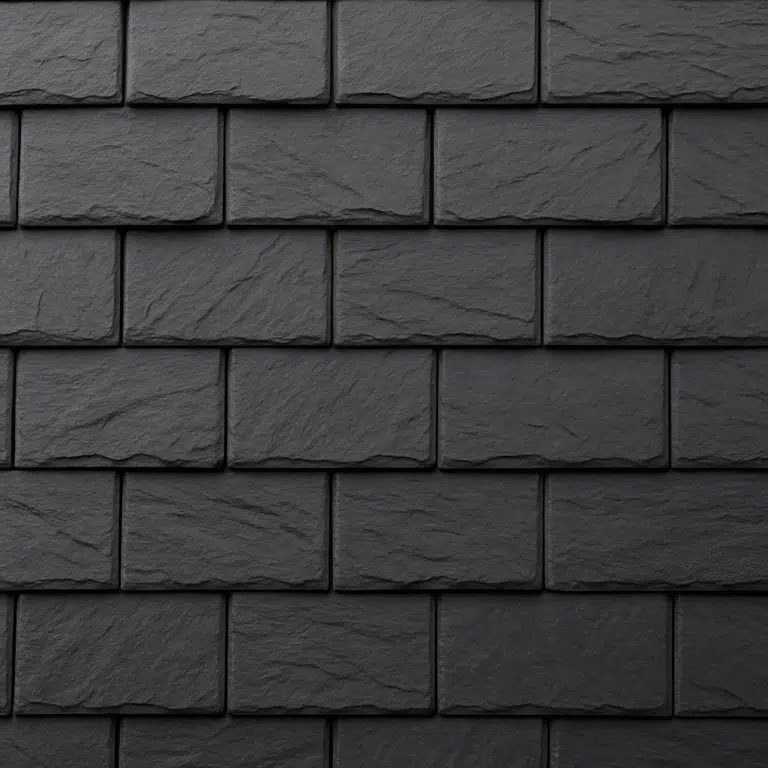 Close-up of dark gray composite roof shingles designed to replicate the texture of natural slate, installed on a residential roof under soft daylight.