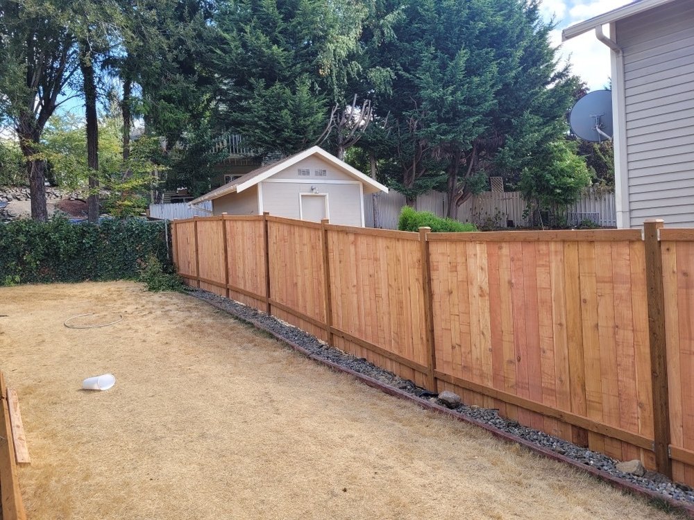Cedar fence installation in Puyallup, WA by Orca Roofing & Exteriors.

