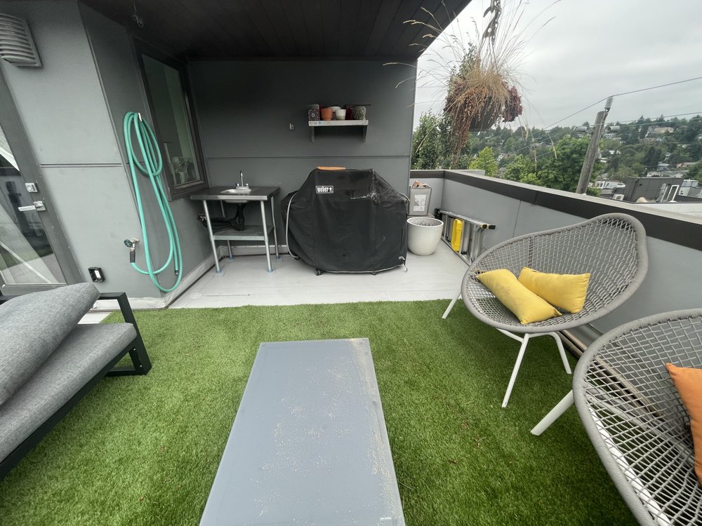 Durable VersiFlex PVC deck with stylish composite pavers in Seattle.

