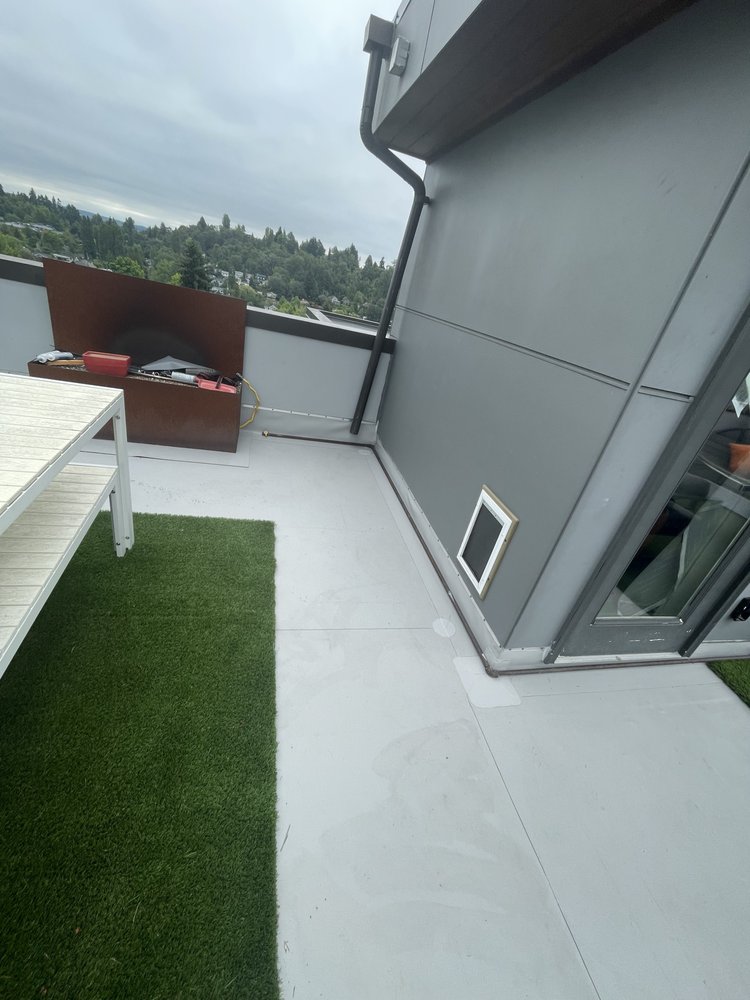 Contemporary Seattle deck featuring Versico VersiFlex and gray pavers.