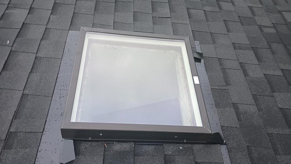 Modern roofing upgrade with Northgate shingles, skylight, and gutters in Bothell.

