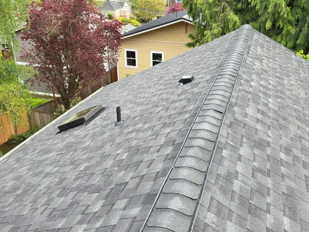 Bothell property with a unified roof, skylight, and gutter system by Orca Roofing.







