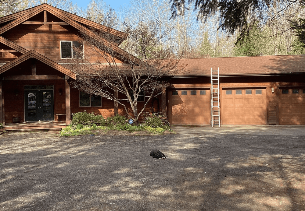 Before and after of a professional roof cleaning in Carnation by Orca Roofing & Exteriors.