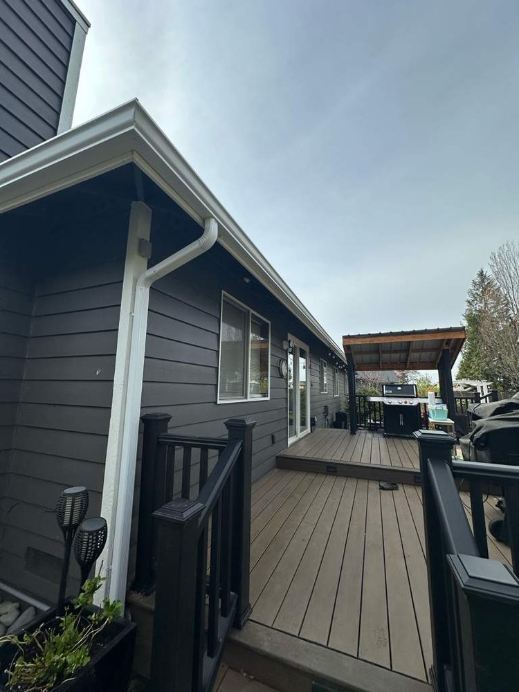 Upgraded gutters protecting a home from water damage, installed by Orca Roofing & Exteriors.