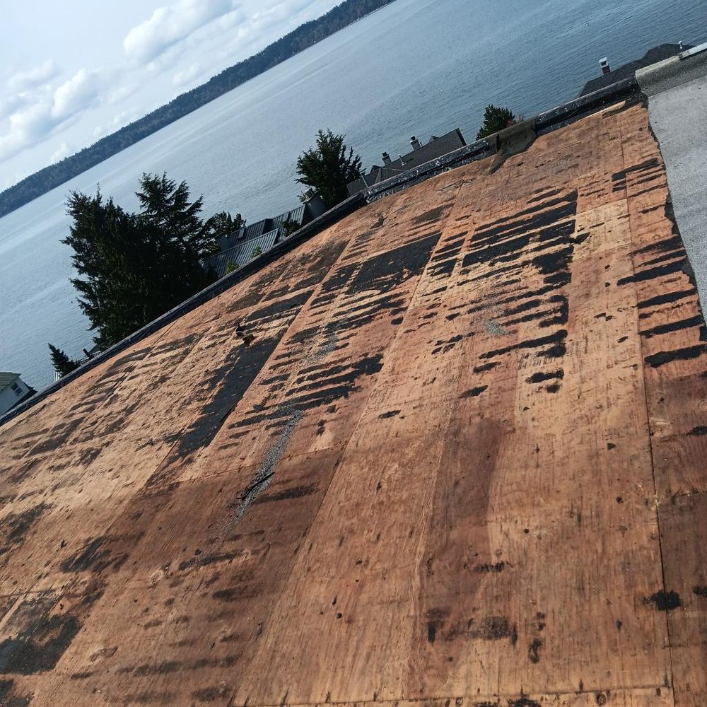 Combined asphalt shingle and PVC flat roof installation in Seattle.