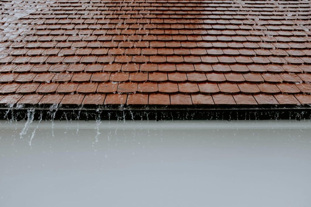 Tile roof vs shingle roof durability comparison with visible weather impact