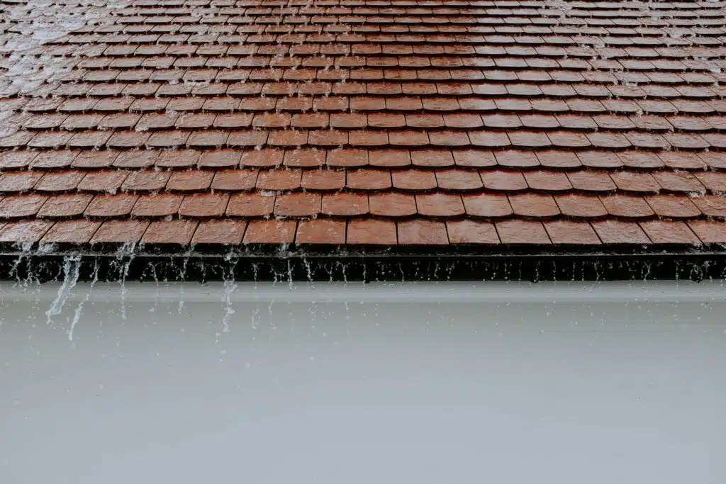 Tile roof vs shingle roof durability comparison with visible weather impact