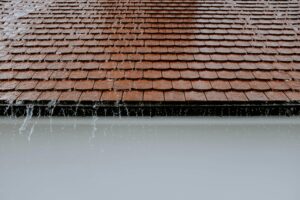 Tile roof vs shingle roof durability comparison with visible weather impact