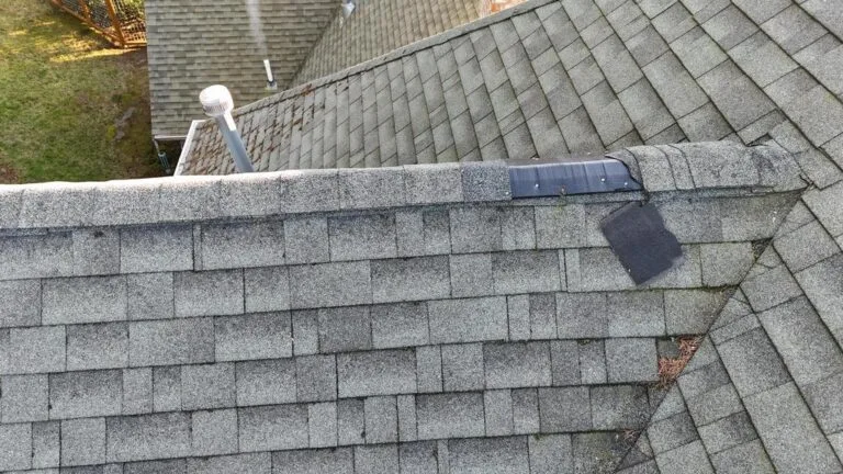 Replacing damaged shingles during an emergency roof leak repair