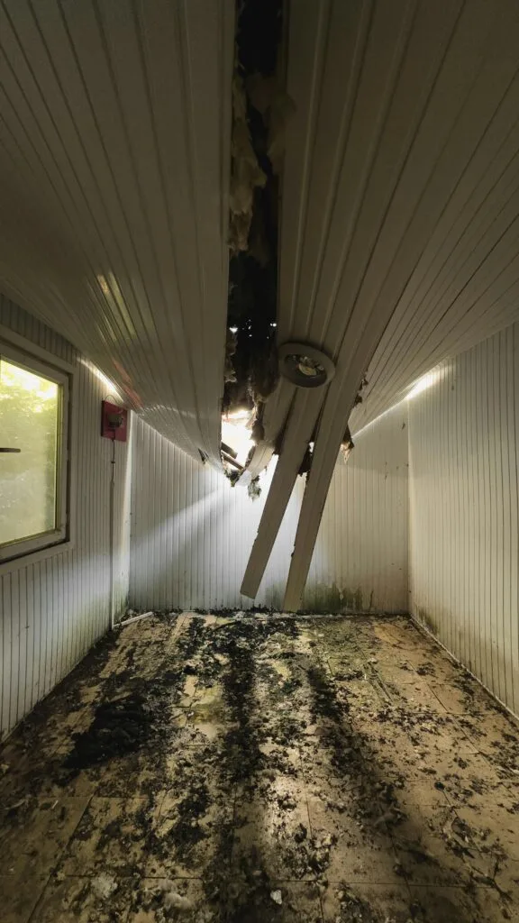 Roof with visible storm damage after heavy rain in Bellevue
